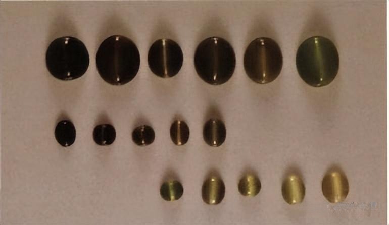 Taiwanese honey cat's eye nephrite jade showing sharp chatoyancy and a silky amber-like luster.