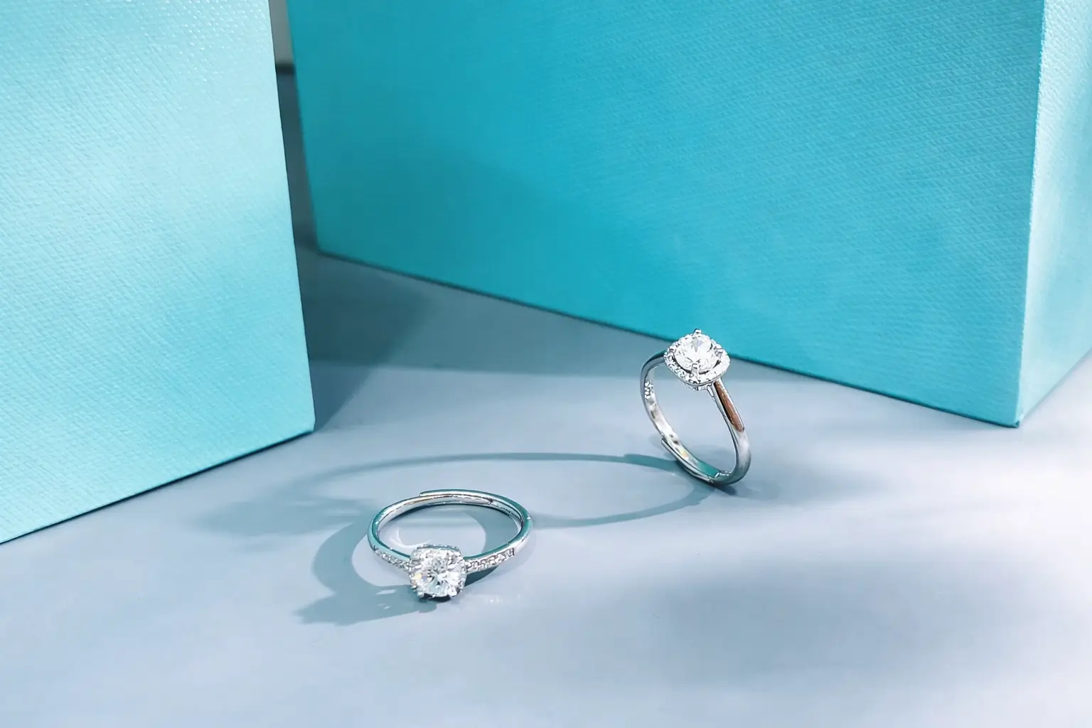 Two Jewea Asscher cut moissanite rings displayed side-by-side to showcase their signature "sugar cube" clarity and precision.