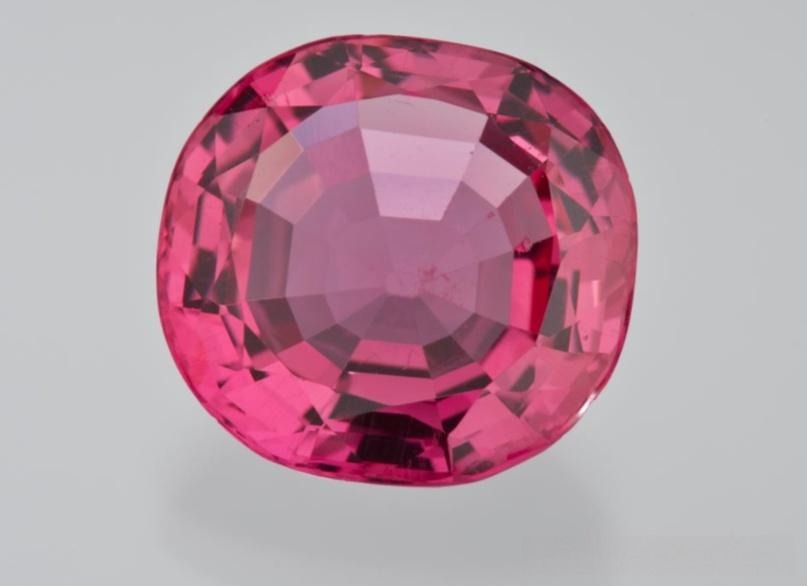 Exceptional 14-carat cushion-cut gemstone exhibiting intense pinkish-red saturation and clarity.