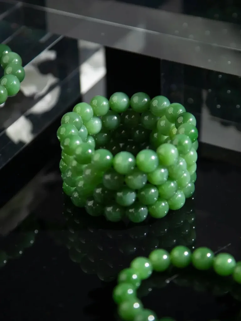 Russian nephrite bead bracelet from Mine 32 showing varied green tones and visible stone texture.