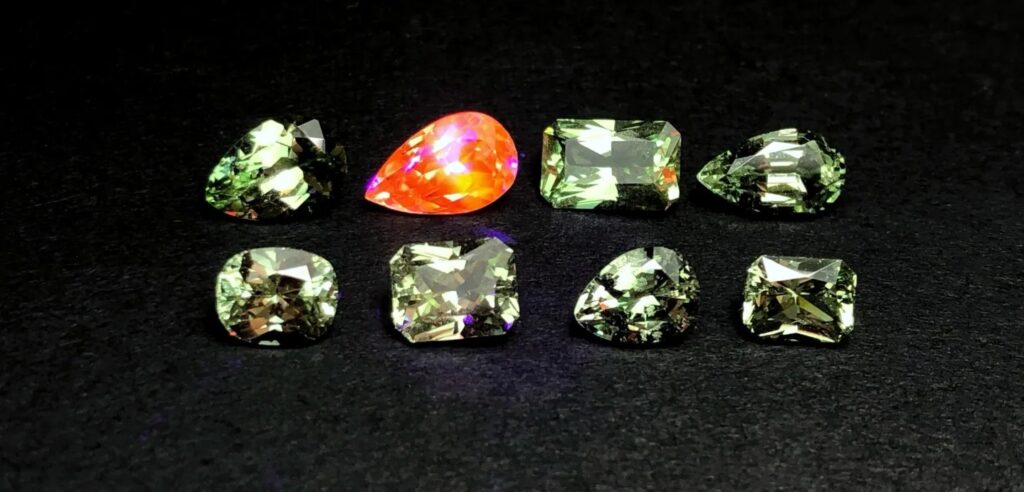 Vibrant orange-yellow fluorescence of Merelani Mint Garnet under UV light.