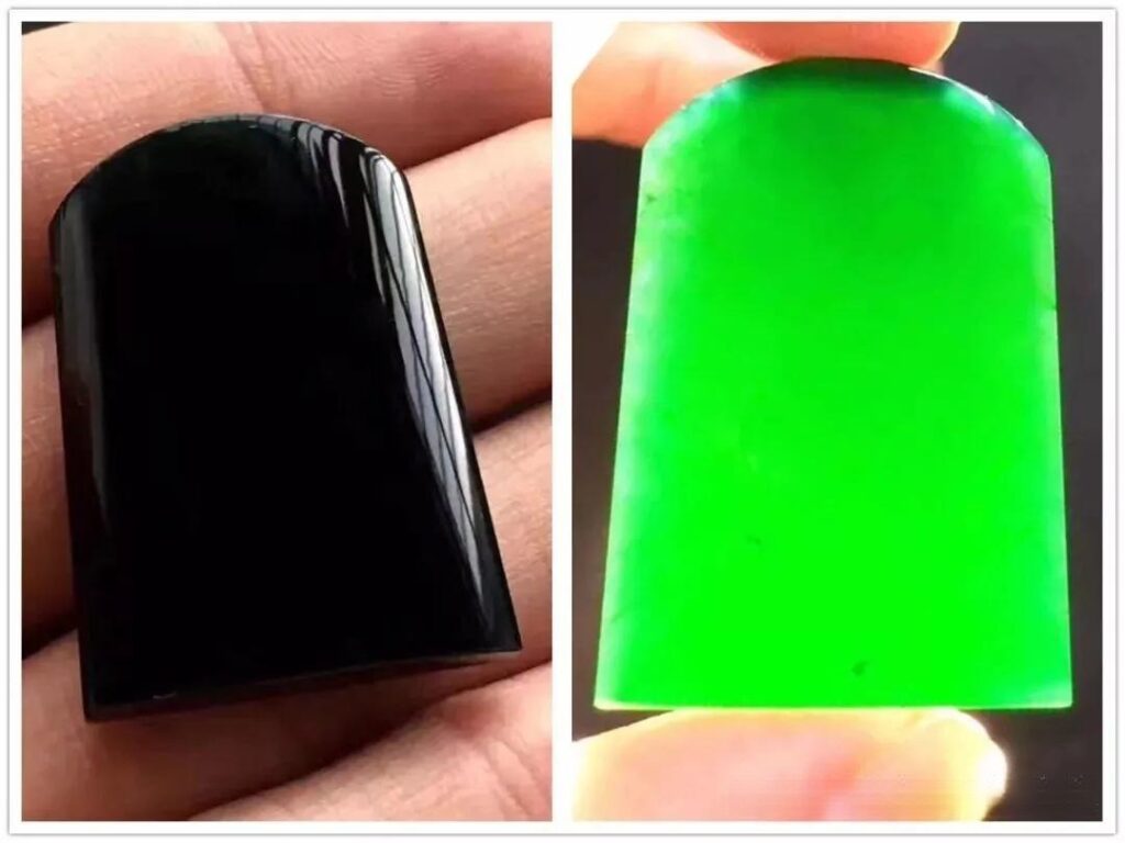 A black jadeite pendant appearing solid black in reflection but vivid green under transmitted light.