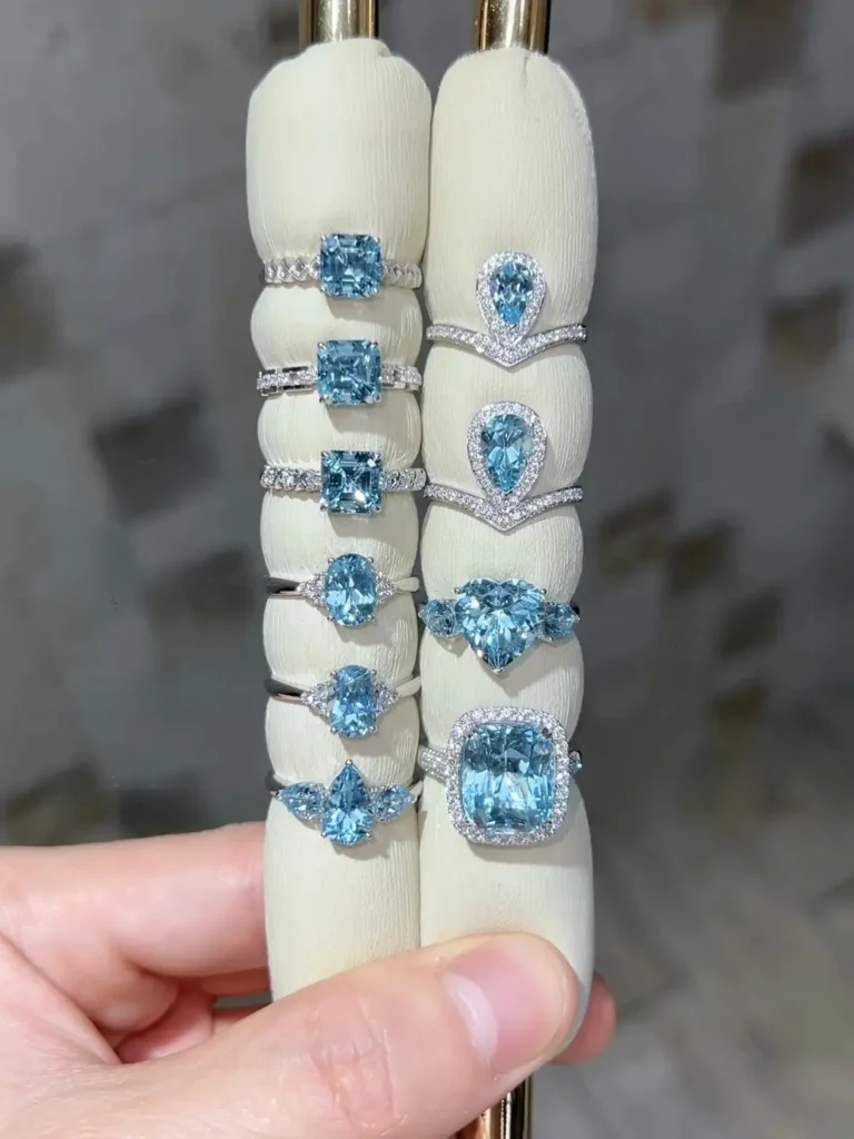 A collection of blue beryl rings in various vintage and modern gold settings.