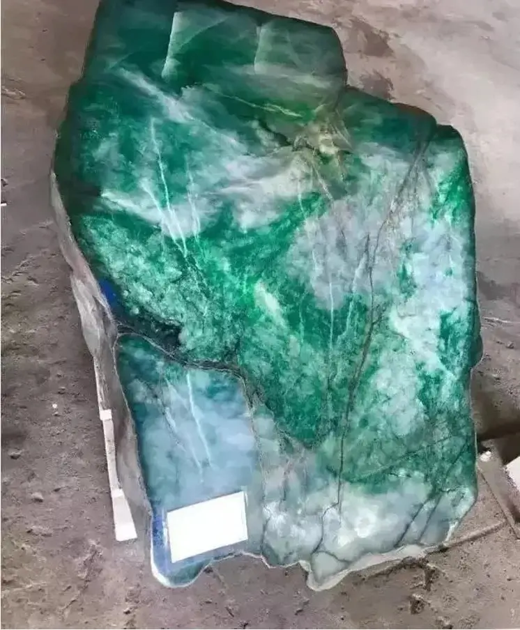 Raw Burmese jadeite with a brown crust and green core, ready for Grade A Jadeite Certification testing.