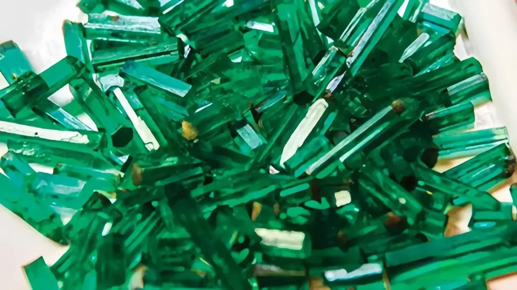 Long, slender hexagonal Panjshir emerald crystals in their natural rough columnar state.