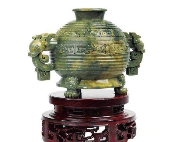 A Panlong Jade carving from Jilin, China, showing its signature yellow-green quartzite coloration.