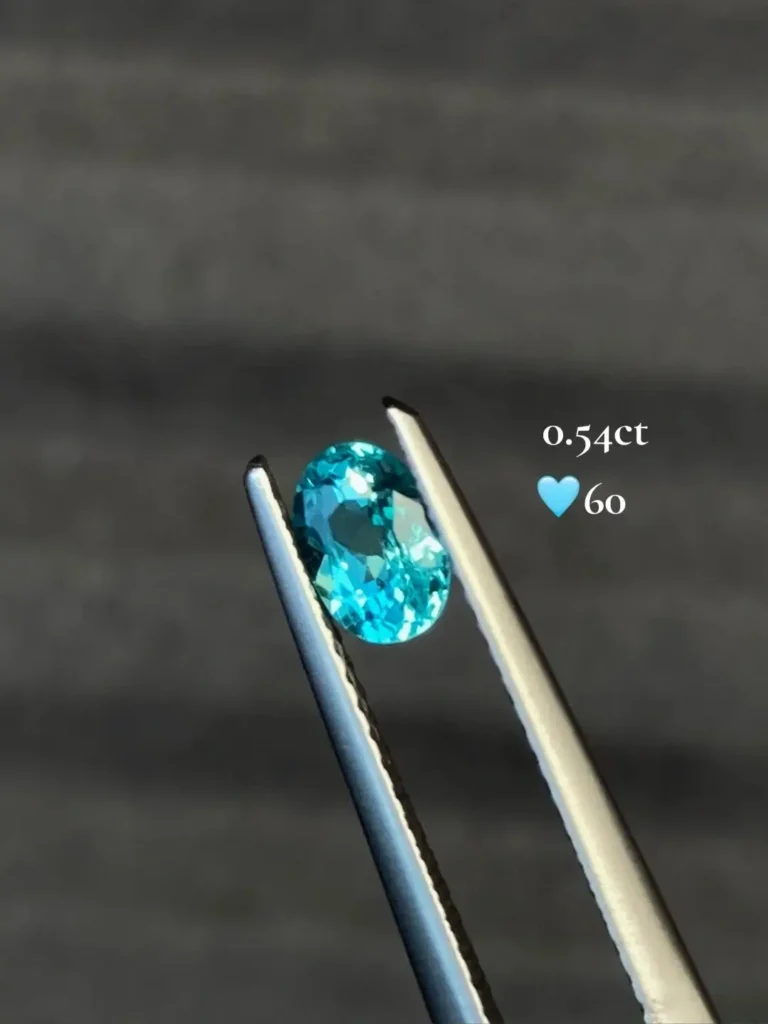 0.54-carat Paraiba Color Apatite gemstone showing saturated neon blue-green color in faceted form.