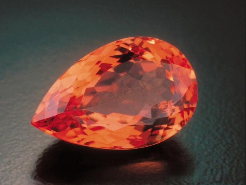 Faceted Imperial Topaz gemstone with rich golden yellow and vibrant orange saturation.