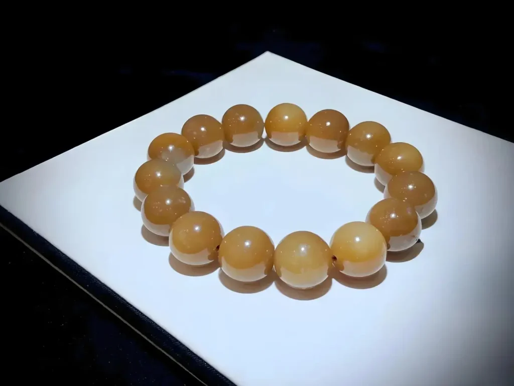 Natural Qiemo Sugar Jade bracelet with rich honey tones.