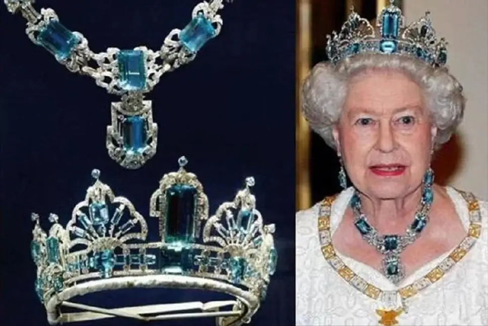 Queen Elizabeth II wearing the Brazilian Aquamarine tiara and necklace set with large blue gems.