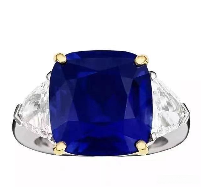 A luxury gold ring featuring a vivid royal blue sapphire center stone surrounded by diamonds.