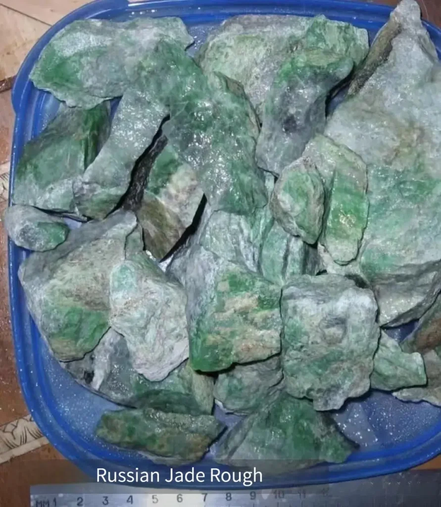 Raw Russian jadeite from the Ural Mountains, showing green tones and natural texture of the stone.