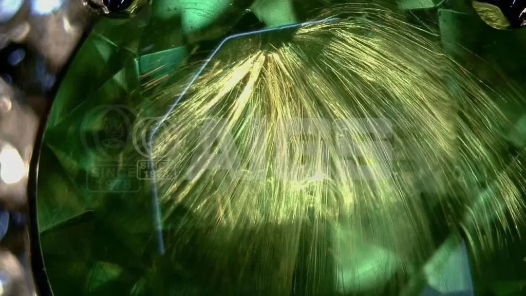 Russian Tsavorite garnet from the Ural Mountains showing tail-like inclusions radiating from the gem’s center.