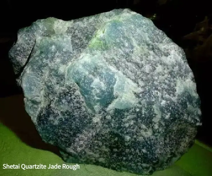 Rough Shetai Jade stone from Inner Mongolia, showing natural green quartzite texture and semi-translucent areas.