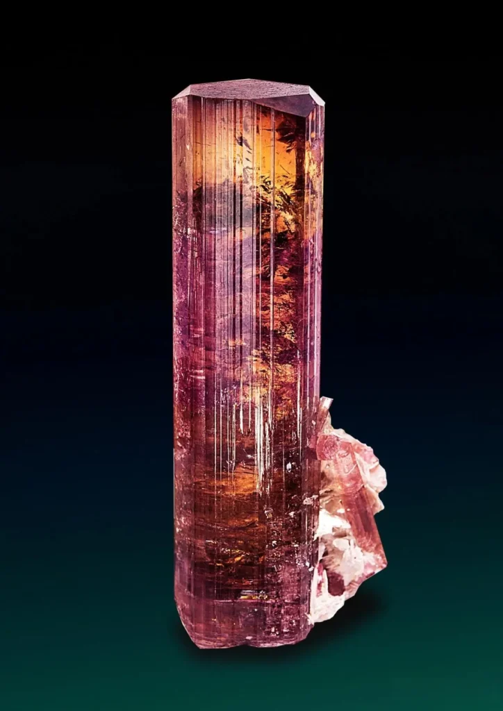 Red Russian tourmaline from the Ural Mountains, showing deep, vivid color and natural crystal form.