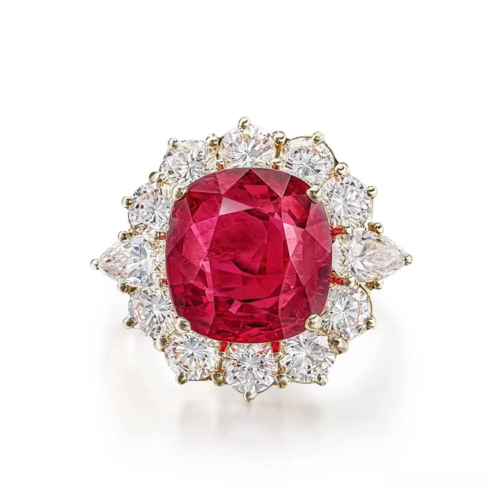 A Van Cleef & Arpels ring set with a 6.15-carat Thai ruby and side diamonds on a white background.