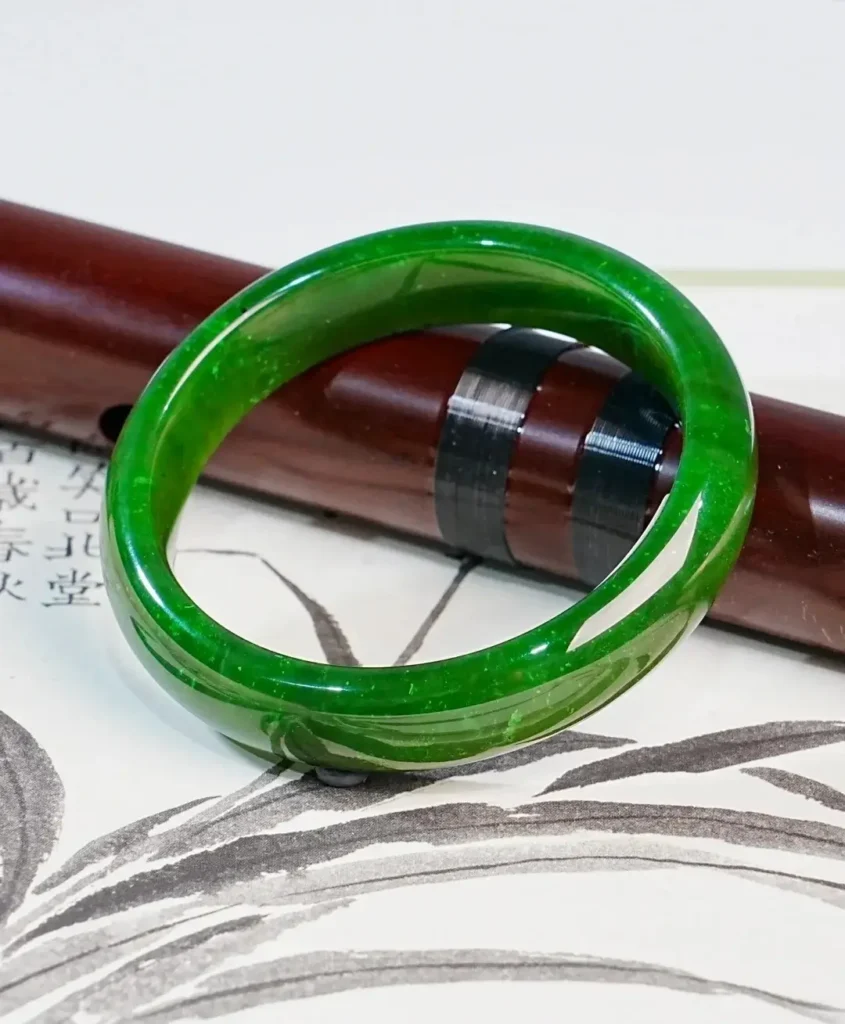 Vibrant AAA-grade Arctic nephrite jade bangle with a fine grain and vivid "Yang" green color.
