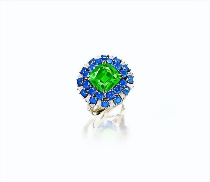 A 4.25ct cushion-cut chrome tourmaline ring accented with sapphires and diamonds in a premium setting.