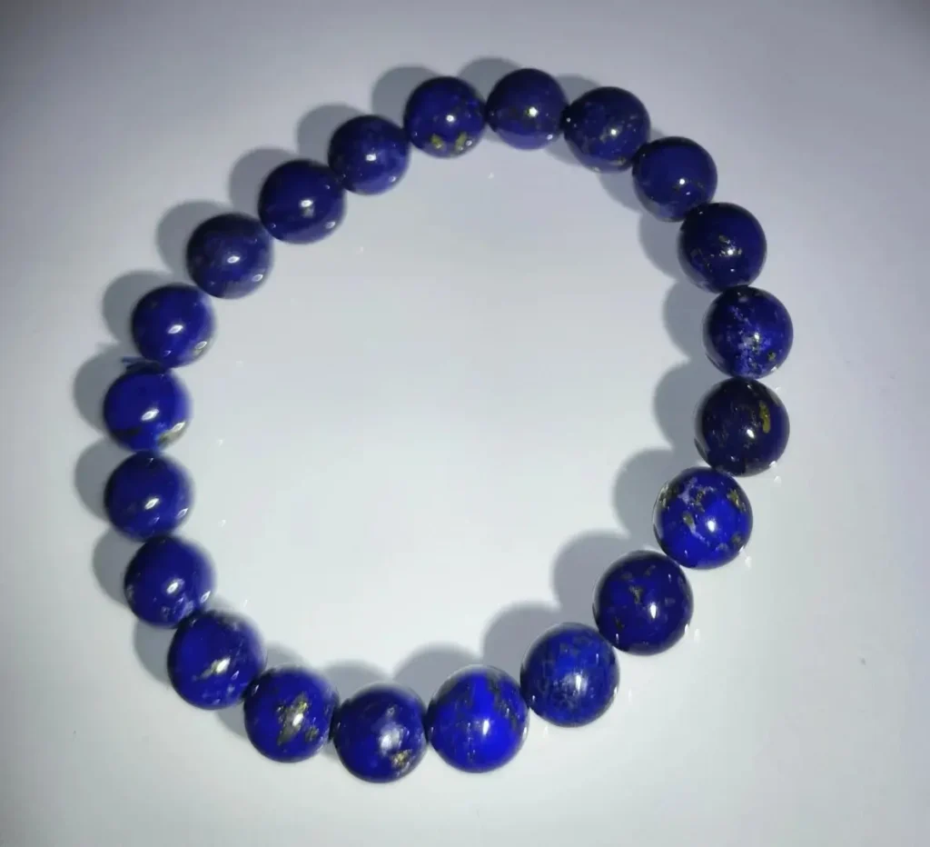 8mm old-mine lapis lazuli beads featuring dense, cloudy gold pyrite and varied blue tones.