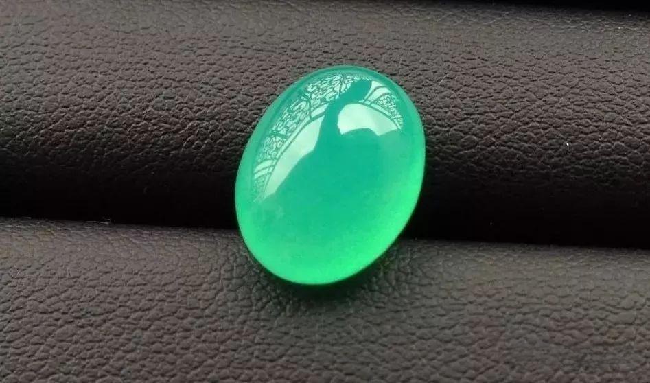 A translucent, apple-green Australian chrysoprase cabochon with a smooth, jelly-like texture.