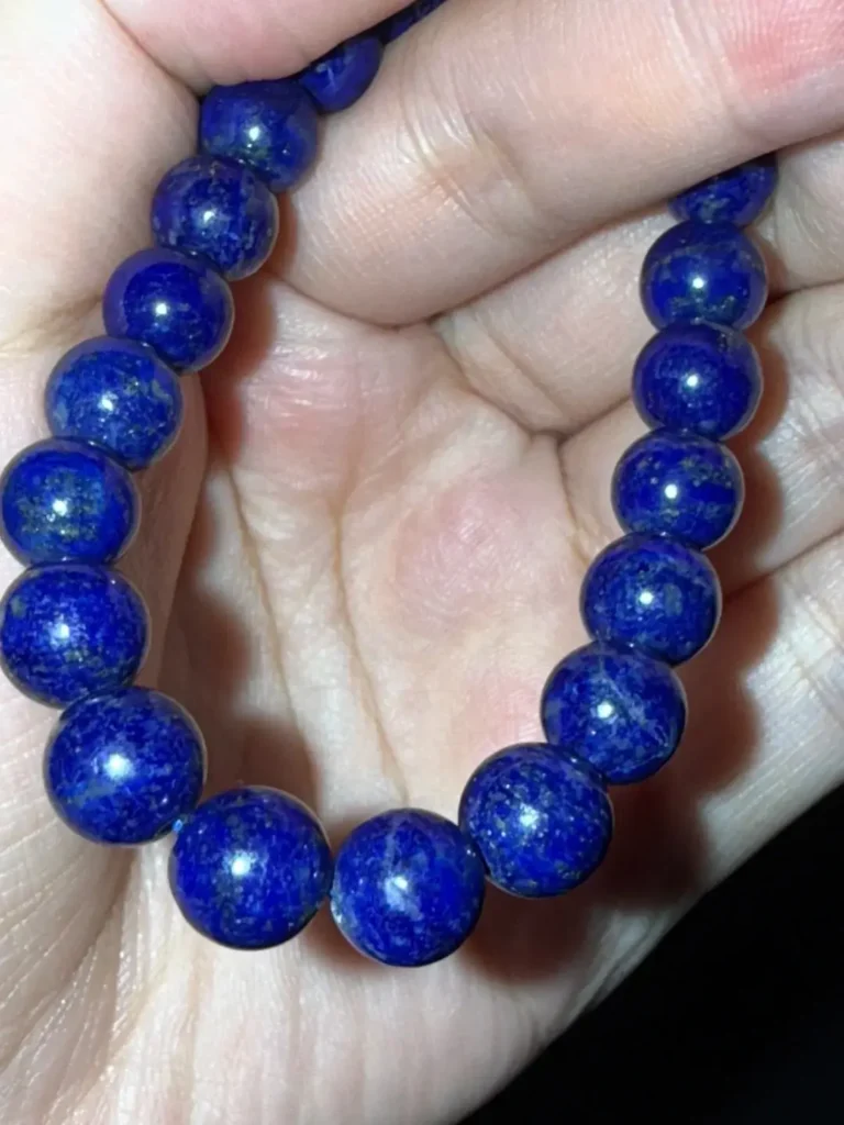 Basic lapis lazuli bracelet with pale blue color and heavy white calcite mottling.