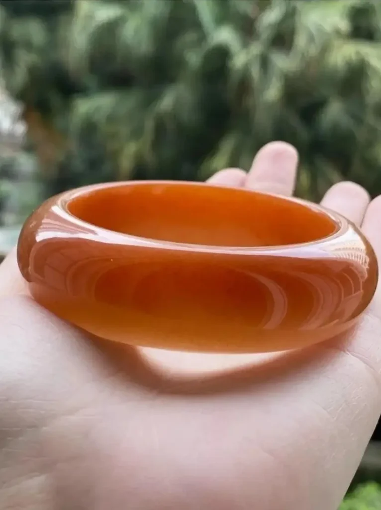 A warm beeswax yellow bracelet with a glossy, even surface finish.