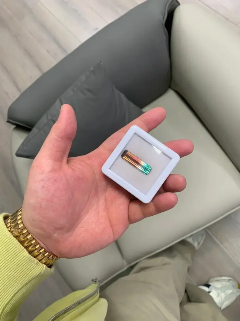 An Afghanistan bi-color tourmaline crystal transitioning from a deep blue to a warm orange-peach hue.