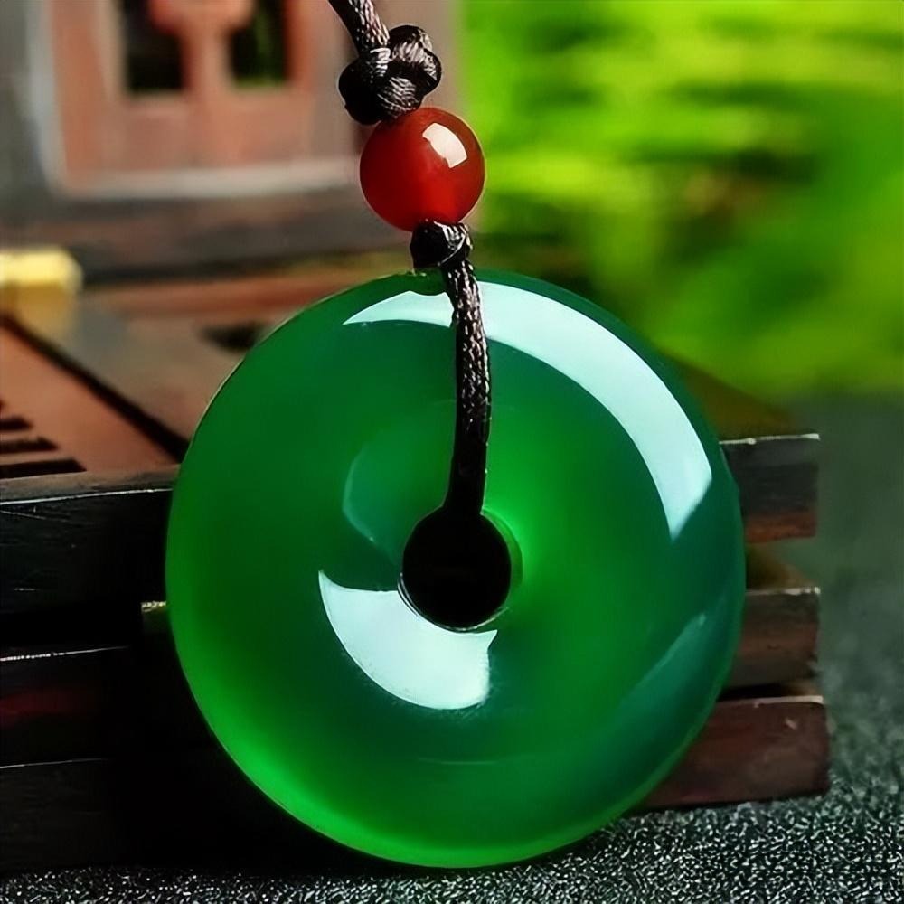 A dyed green chalcedony "Ping An Kou" pendant showing an unnaturally uniform and glassy surface.