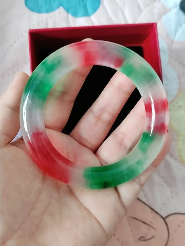 Close-up of a dyed quartzite bracelet with unnaturally vibrant color concentrated in stone fissures.