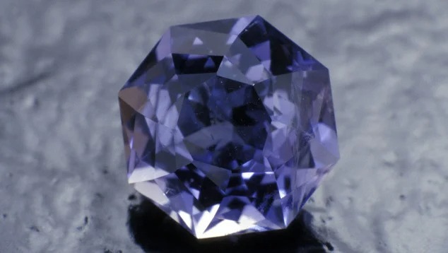 A faceted iolite gemstone displaying its signature violet-blue hue and high clarity.
