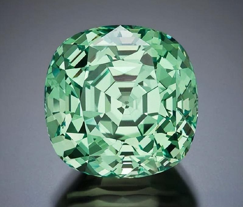 A faceted vanadium chrysoberyl with a vibrant mint-green hue and high clarity from Tanzania.