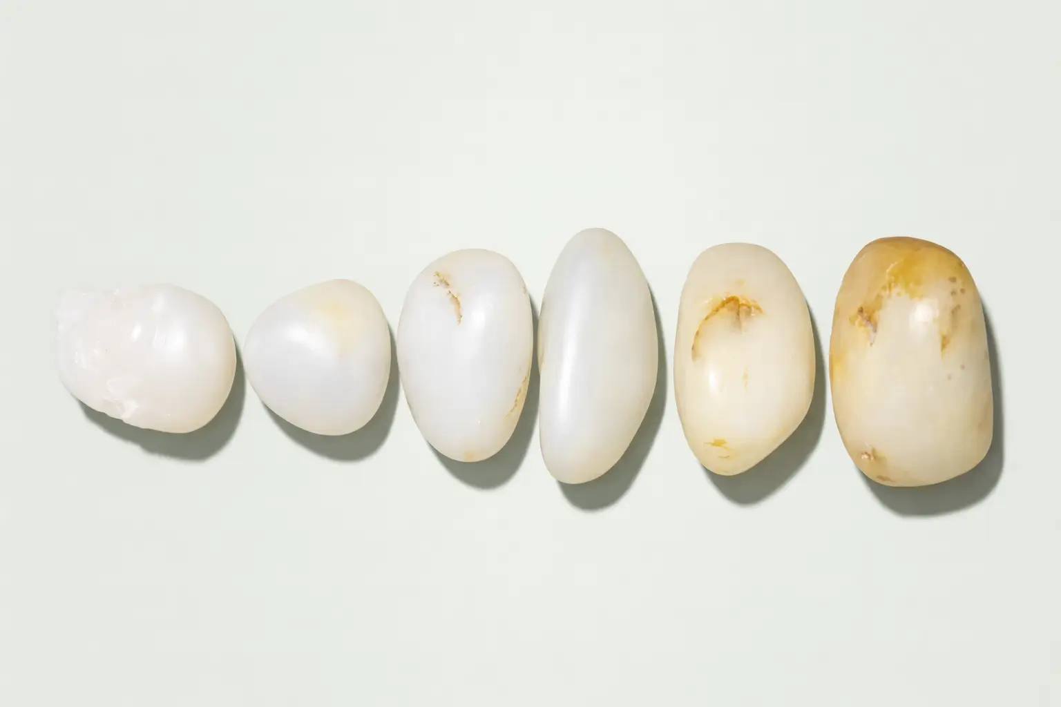 Comparison of Hetian Nephrite Jade stones in Mutton-Fat, Grade 1, and Grade 2 whiteness.