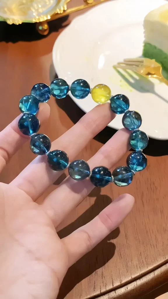 A high-quality gemston bead bracelet featuring a gradient of Indicolite and Lagoon shades.