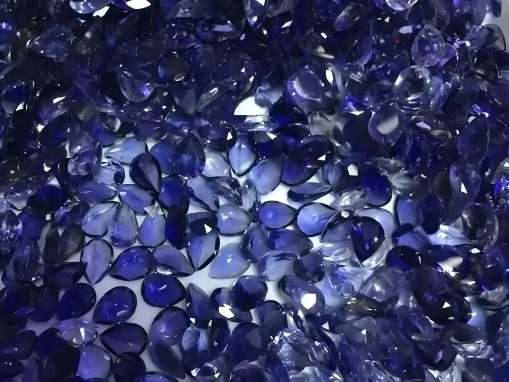 Collection of faceted Iolite gemstones showcasing deep violet-blue body color.