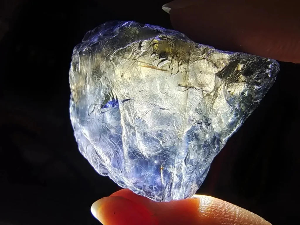 Iolite crystal showing dual pleochroic colors of deep blue and yellow from a single viewing angle.