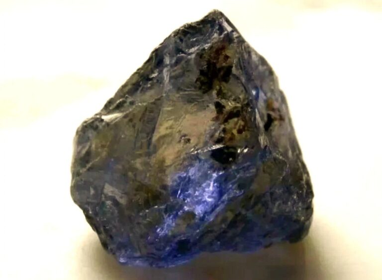 Raw Viking Compass Stone specimen displaying trichroic hues of yellow, violet, and blue.