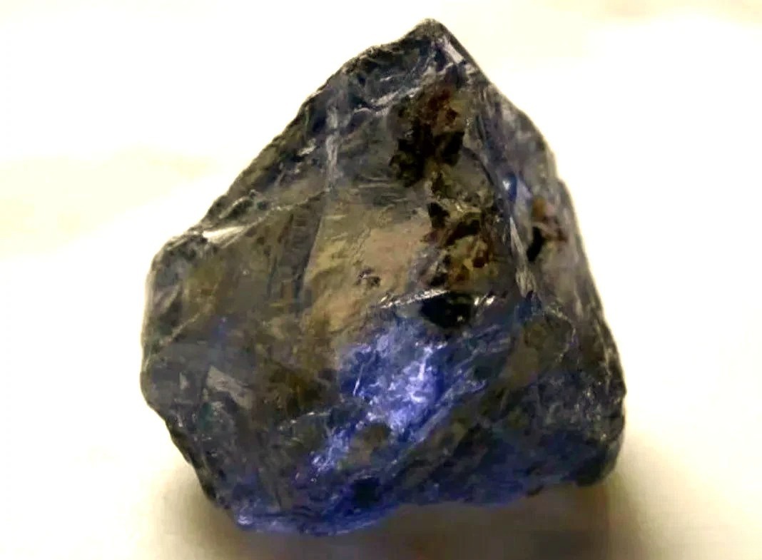 Raw Viking Compass Stone specimen displaying trichroic hues of yellow, violet, and blue.