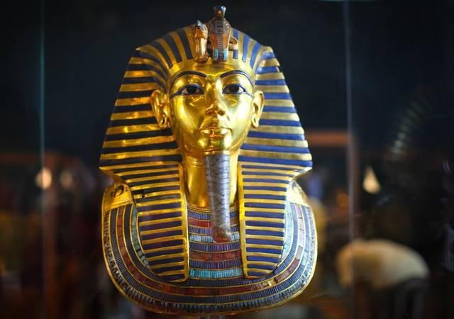 Detail of King Tutankhamun's golden funerary mask with deep blue lapis lazuli inlays.