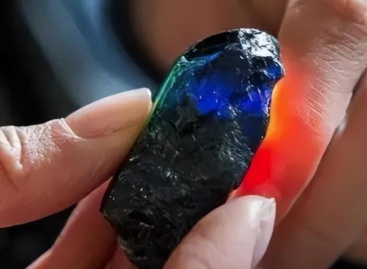 Large rough Kings Plains sapphire showing intense blue and green pleochroism in natural light.