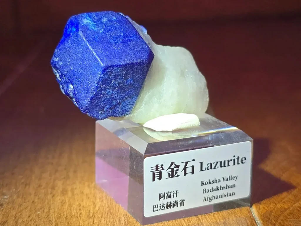 A rare, well-formed cubic lapis lazuli crystal on a white calcite matrix.