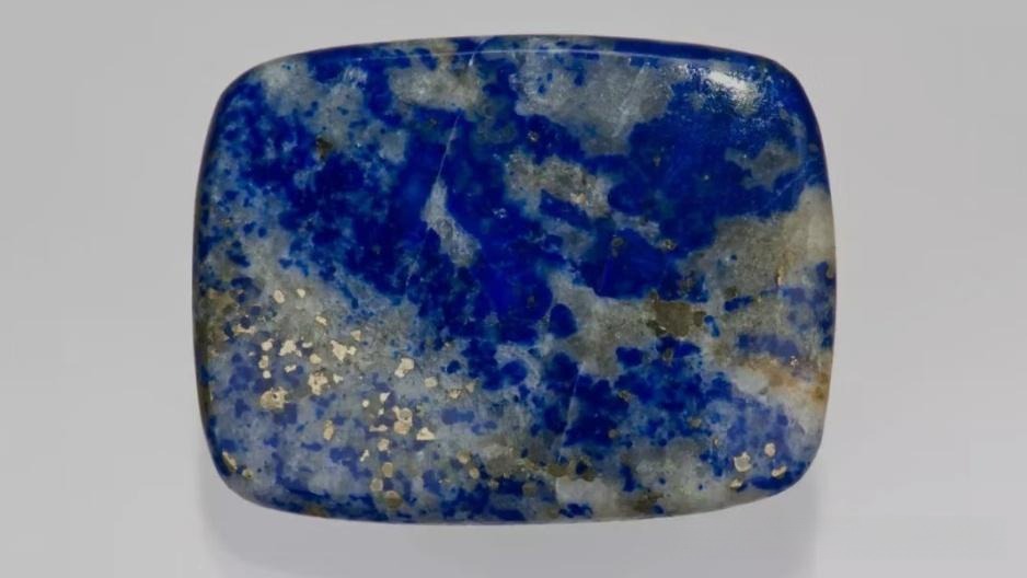 Ultramarine Stone with large white calcite patches and messy, irregular golden pyrite inclusions.