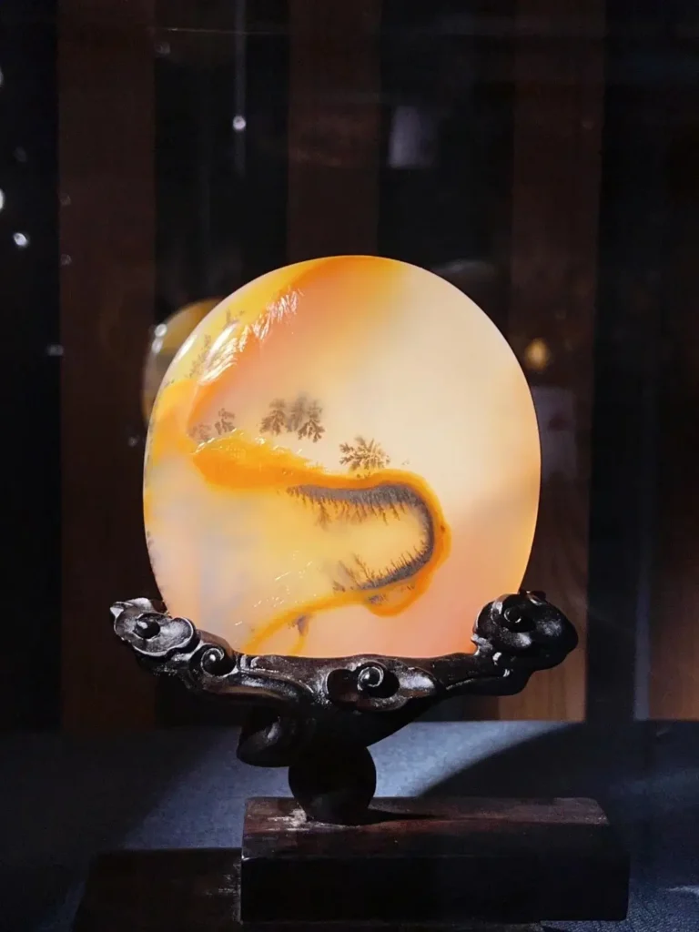 Museum-grade Huanglong Jade carving by Master Liu Dong, featuring intricate, fine-line details.