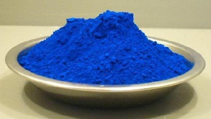 Vibrant blue powder ground from natural lapis lazuli stone used for ultramarine pigment.