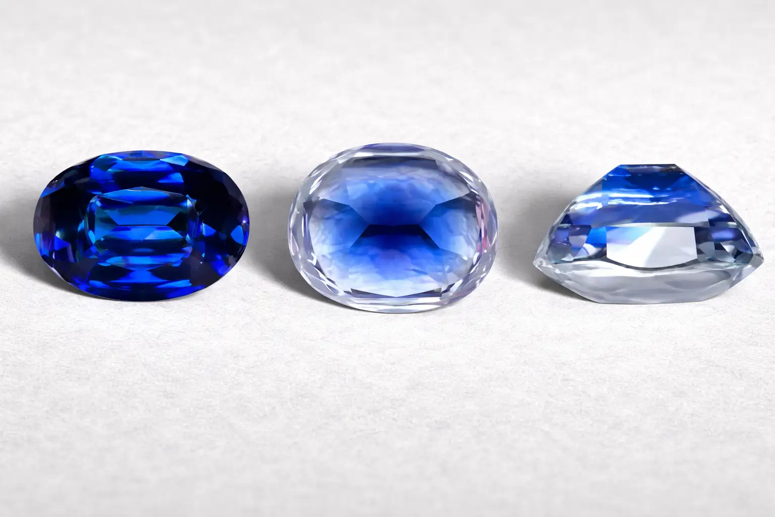 Three-view comparison of an Ottu Sapphire showing vivid blue face-up vs. pale profile and culet.