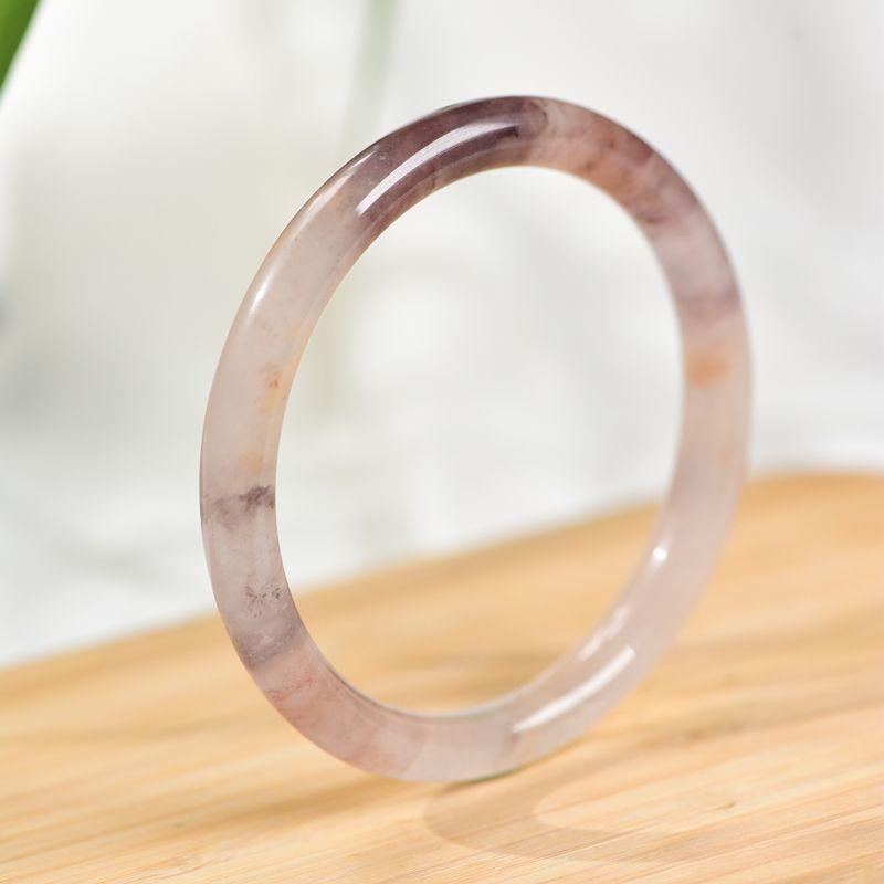 A quartzite bracelet with fine texture and artistic floating inclusions.