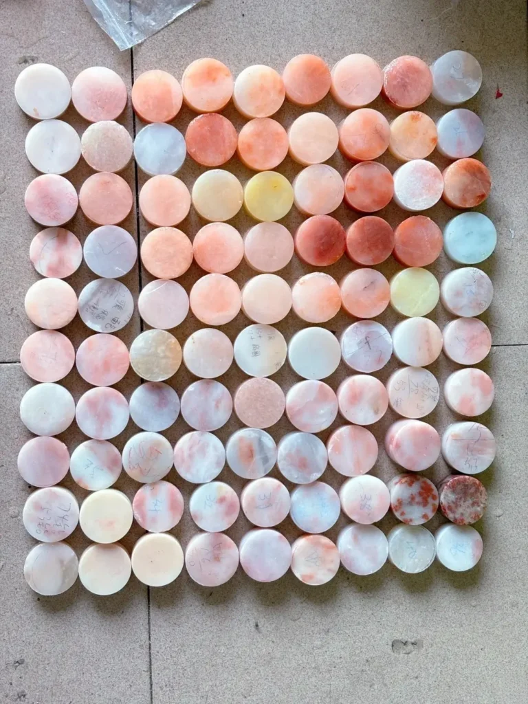 An assortment of pink stones displayed on the floor.