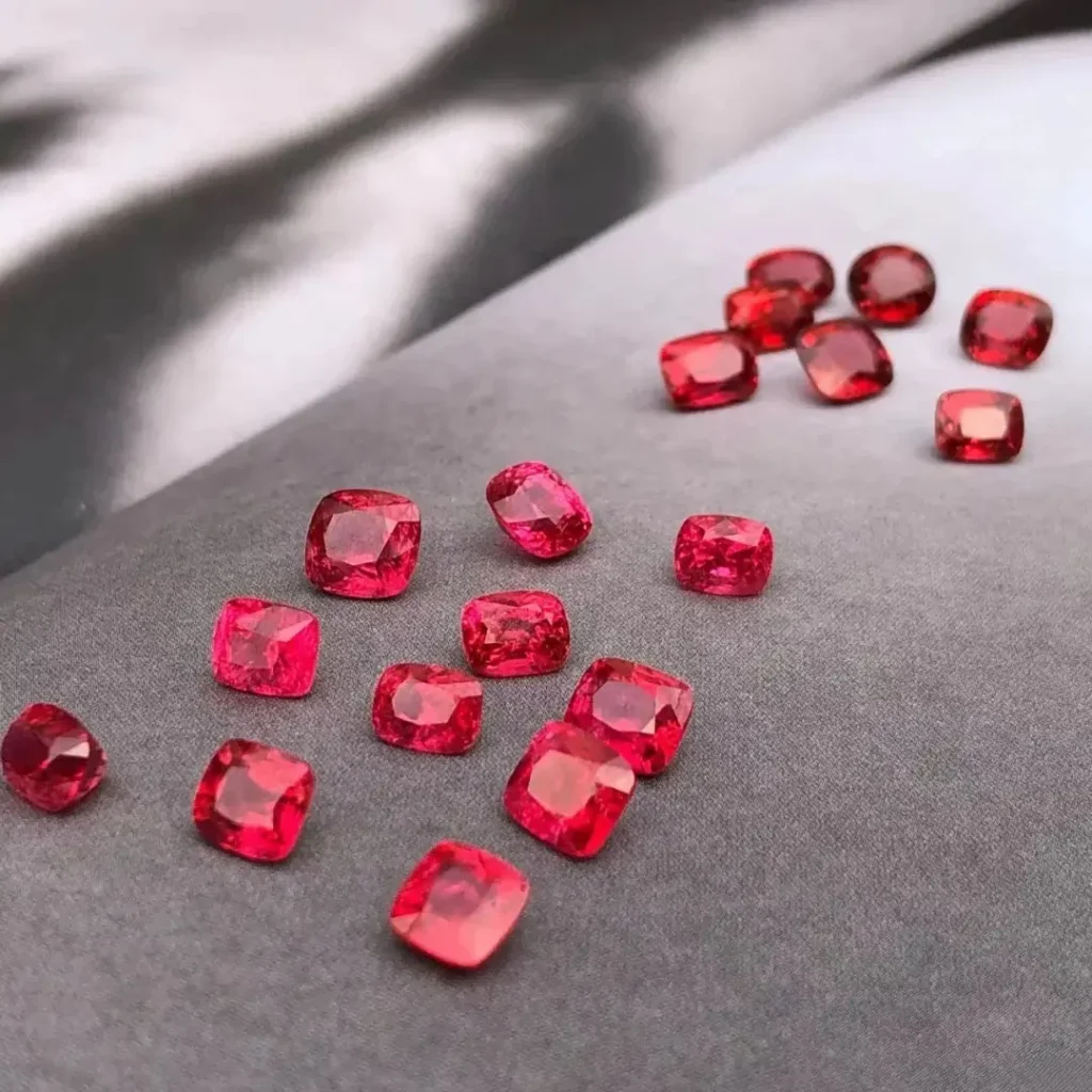 Faceted red Mahenge spinels with a distinctive misty velvet texture and neon red-blue undertones.