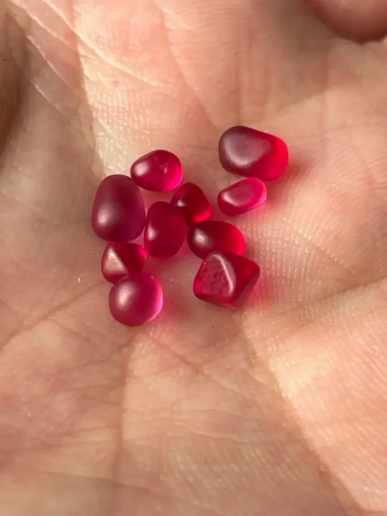 A set of rough Burmese Jedi spinel crystals with intense neon fluorescence.