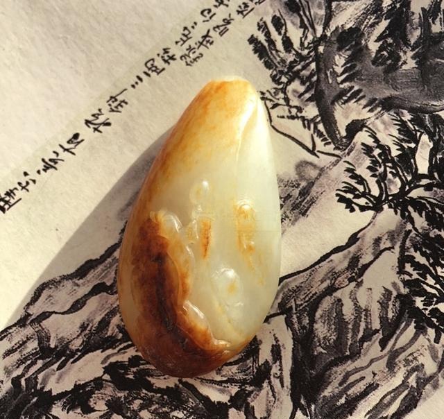 A "Great Achievement" seed jade plaque with visible grain and a loose internal structure.