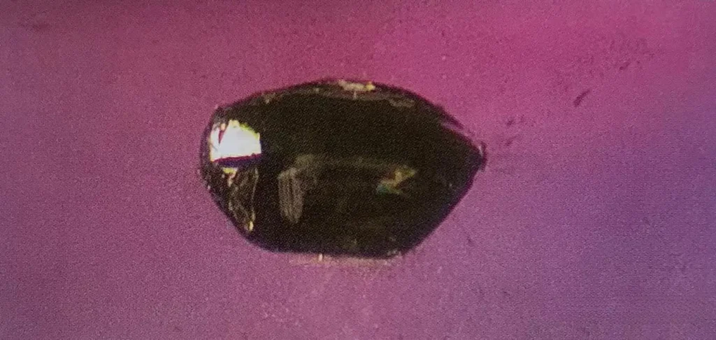 Short prismatic rutile crystals with metallic luster in a Songea sapphire from Tanzania.